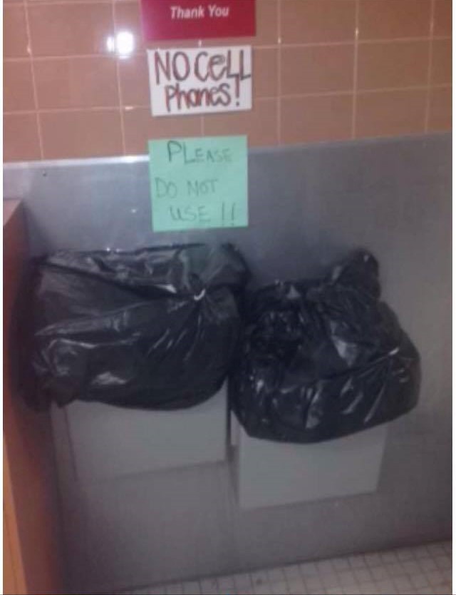 Water fountains in Flint covered with trash bags.