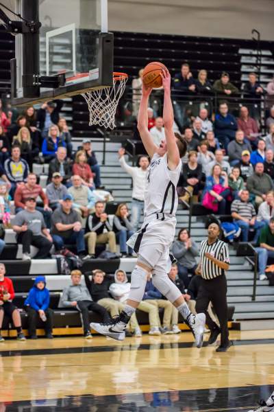 Tyler Bosma dunking at a game.