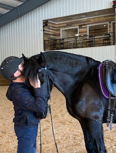 Biondi with his loving companion Brink, a ten-year-old Friesian horse.