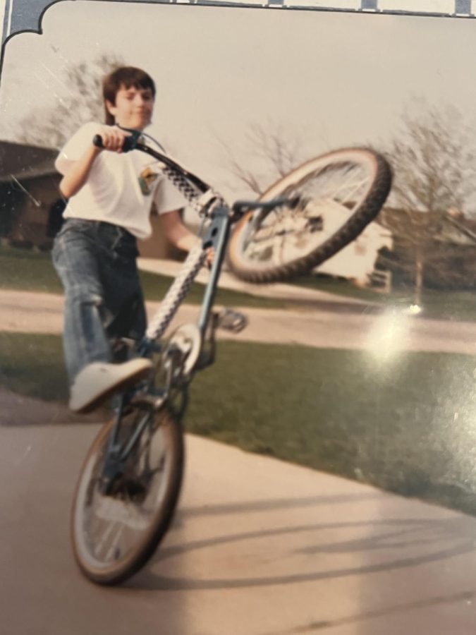 Instructor David Drnek riding a bike as a kid