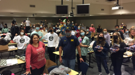 Wrapping the gifts requires many volunteers who always enjoy themselves.