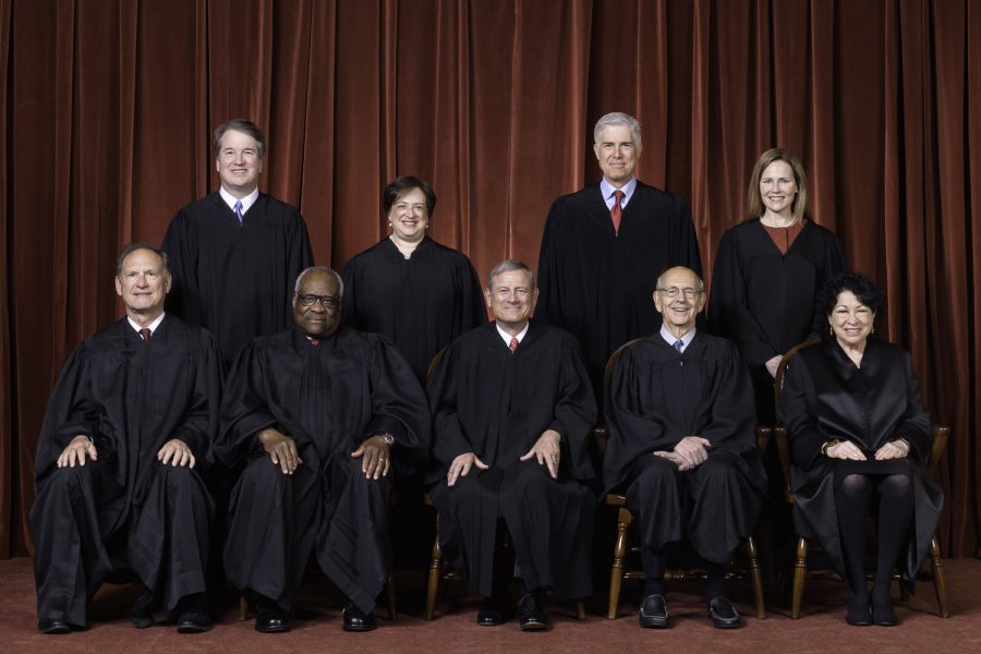 The Roberts Court, April 23, 2021  
Seated from left to right: Justices Samuel A. Alito, Jr. and Clarence Thomas, Chief Justice John G. Roberts, Jr., and Justices Stephen G. Breyer and Sonia Sotomayor. Standing from left to right: Justices Brett M. Kavanaugh, Elena Kagan, Neil M. Gorsuch, and Amy Coney Barrett.  