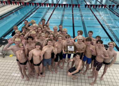 The swim team celebrates their ninth consecutive conference championship.