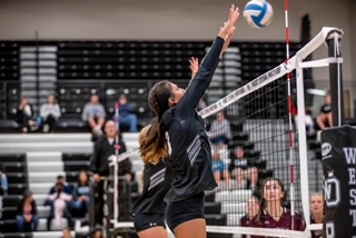 Grandville spikes the ball over as Magaly Lemus attempts to block it. 
