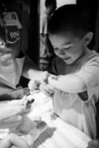 In the hospital, Conor Reidy gets his sisters foot print stamped on his arm.