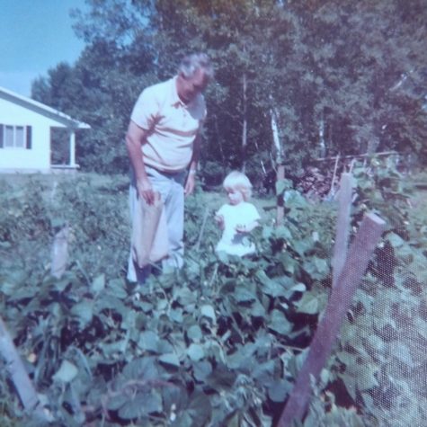 My dad as a child enjoying time with Owen in the garden.
