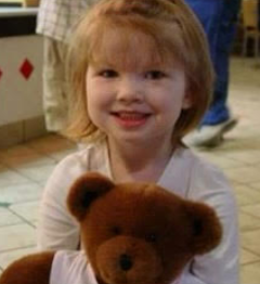 Lily Brigance poses with her teddy bear while out with her mother 