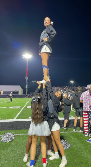 The cheer team strives to use the limited space available.