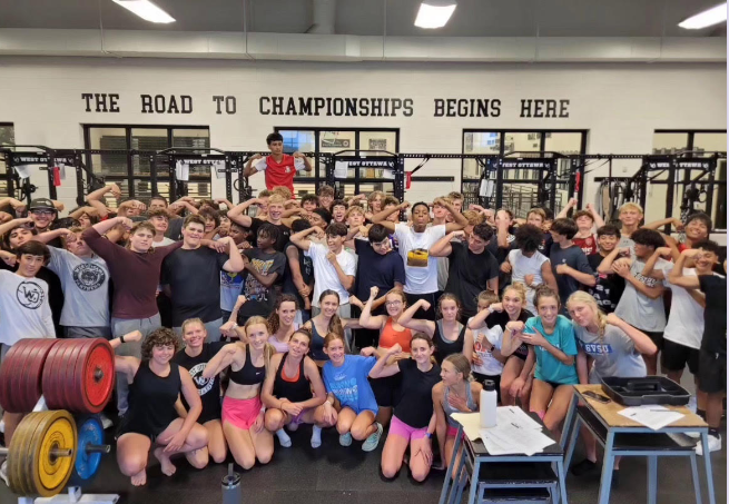 Various West Ottawa teams come together for a group picture after completing their strength training session in the weight room


