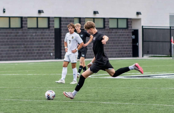 Saunder Sotok taking a free kick on his home field against Grand Haven