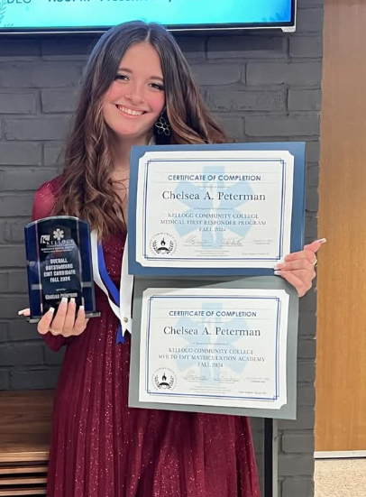 Chelsea Peterman poses with evidence of her success at Kellogg Community College.